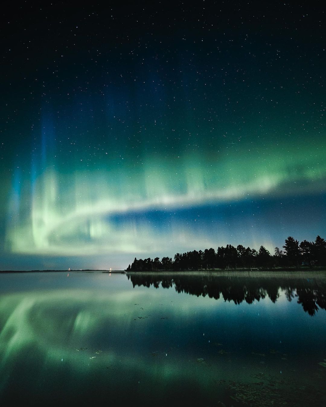 Northern lights over a lake in Finland.