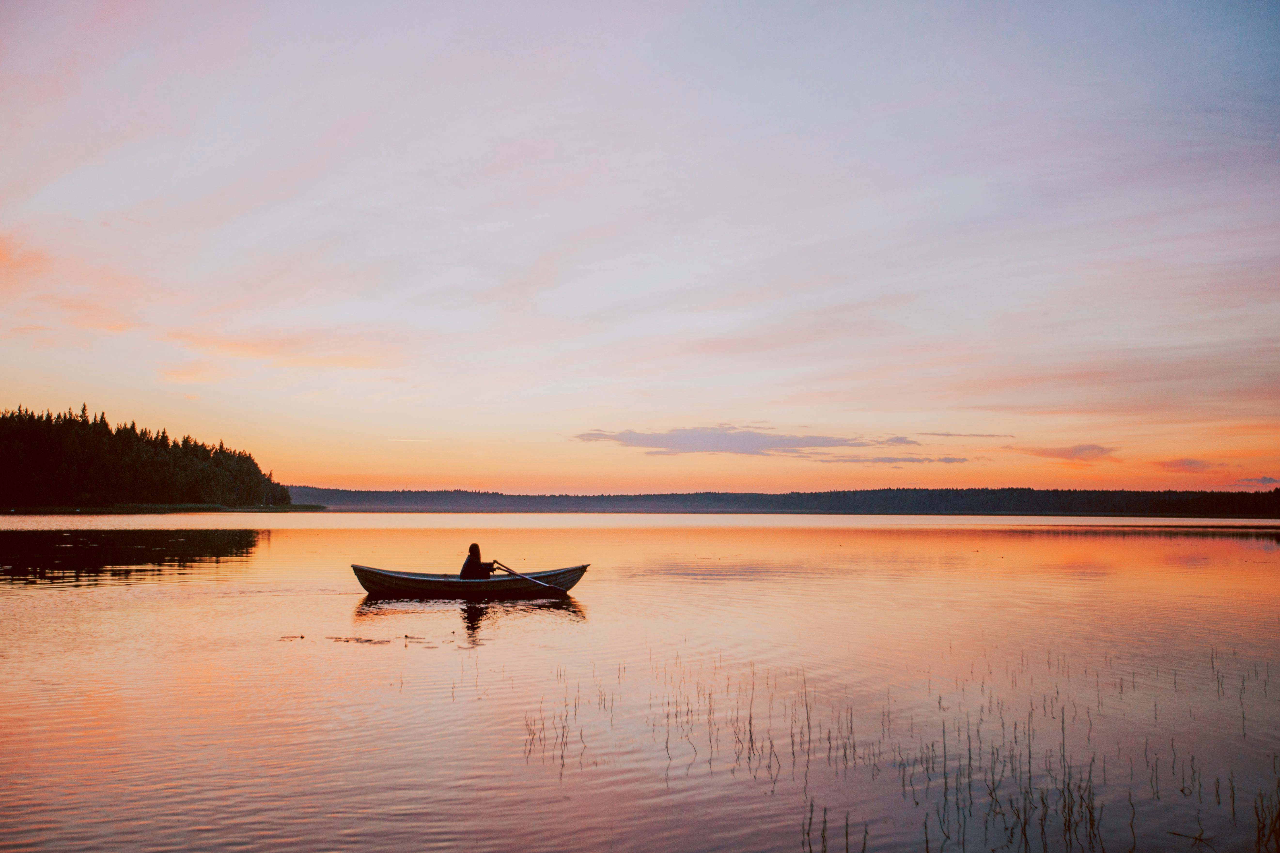 A person on a boat under the Midnight Sun.