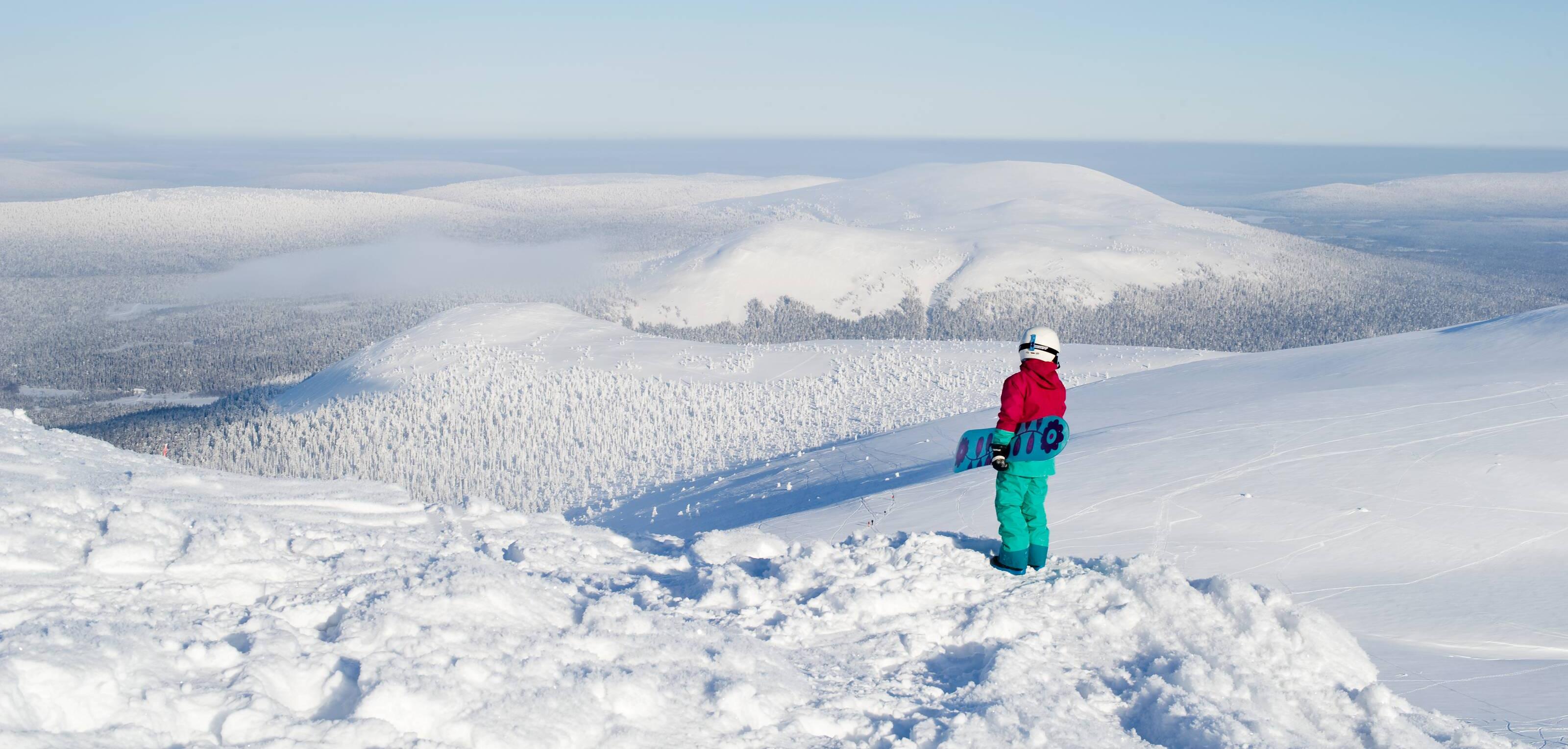 snowboardåkare beundrar ett snöigt fjällandskap